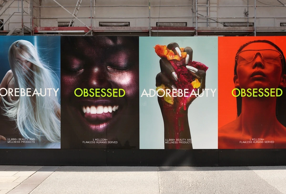 Adore Beauty Obsessed large-format outdoor campaign with vivid beauty portraits and bold campaign typography.
