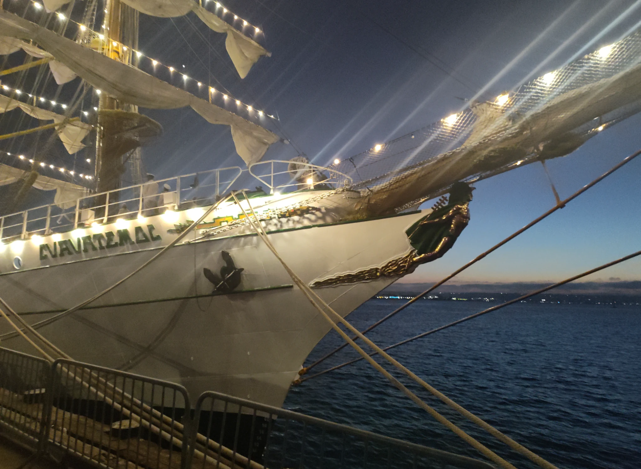 ARM Cuauhtémoc sail training ship illuminated at night, used as a visual metaphor for carrying Mexico’s identity and messages across distances.