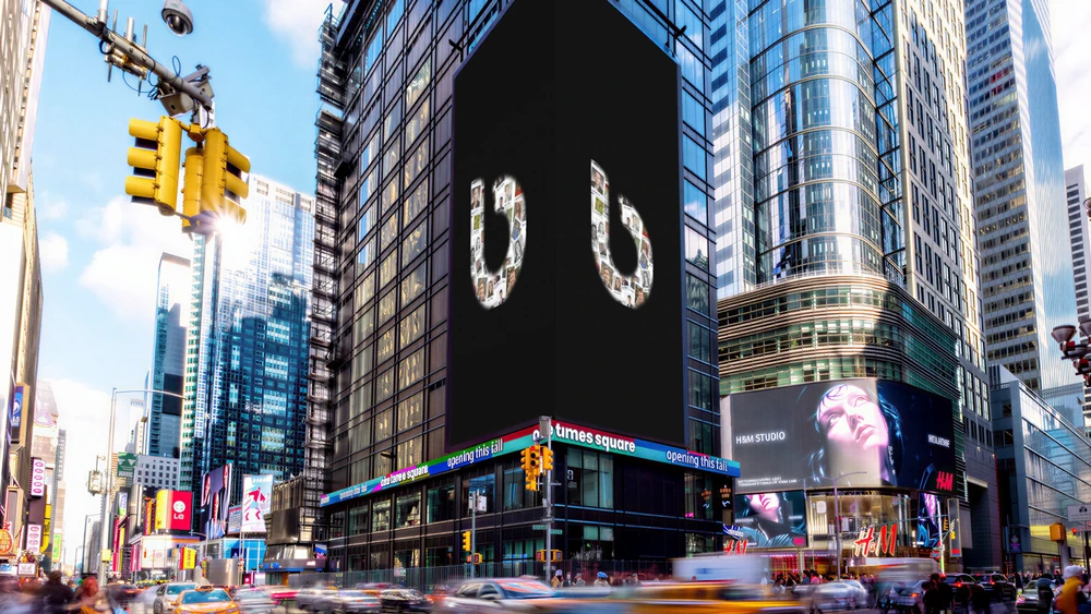 billups Day digital billboard in Times Square displaying the billups b formed from employee photographs as part of a global OOH celebration.