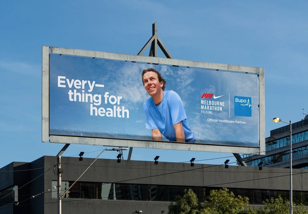 Bupa billboard in Melbourne for the Nike Melbourne Marathon Festival featuring the line Everything for health and Official Healthcare Partner branding.