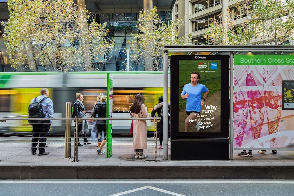 Bupa digital OOH panel near Southern Cross Station featuring a runner and the Why Run campaign.