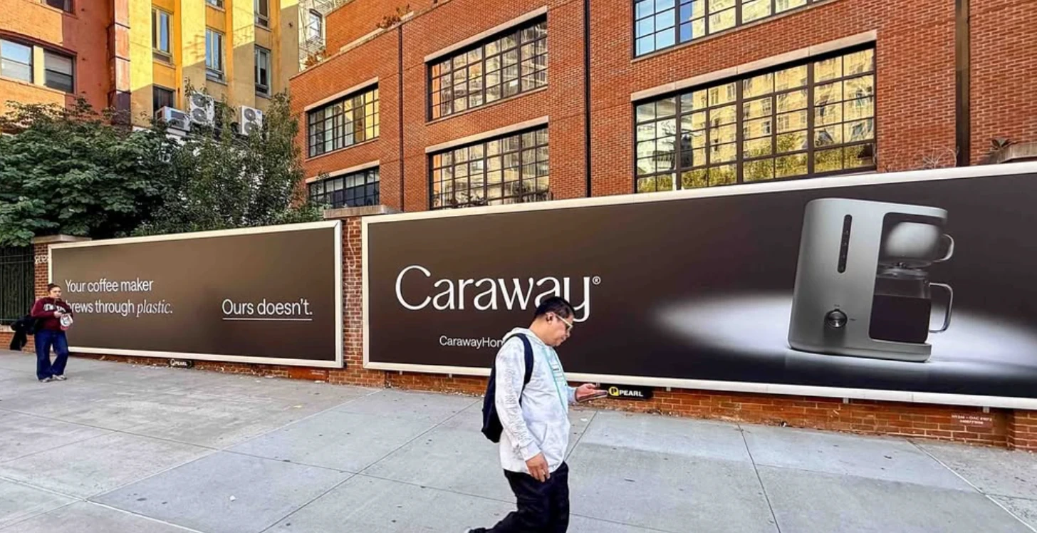 Caraway Home large-format wallscape advertising its coffee maker with the line Your coffee maker brews through plastic. Ours doesn't.