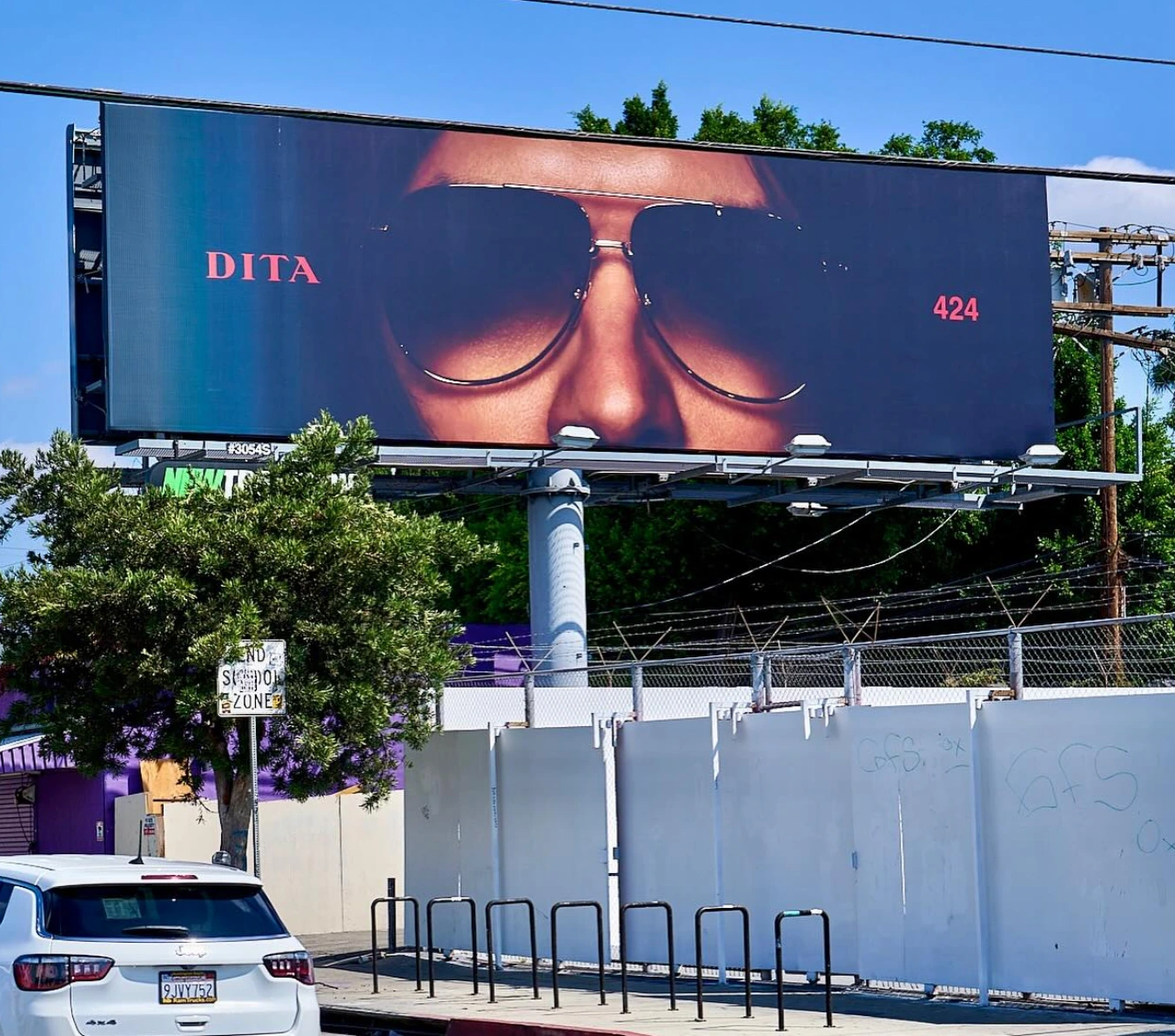 DITA x 424 billboard in Los Angeles featuring a close-up of a person wearing dark sunglasses with minimal DITA and 424 branding.