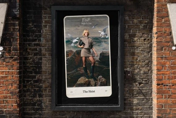 F&F Whatever You’re Dealt outdoor poster featuring The Heist tarot card with a fashion model standing on a rocky coastal landscape.