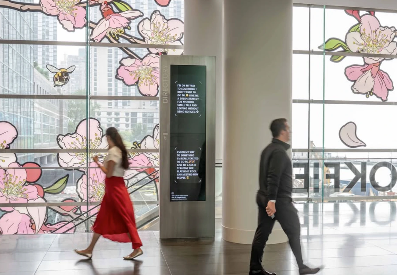 Google Gemini prompt screen at Brookfield Place positioned beside passing pedestrians and large illustrated windows.
