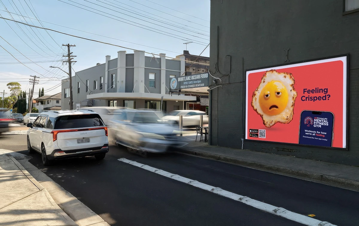 Gotcha4Life outdoor billboard asking Feeling Crisped with an exhausted fried egg character and Mental Fitness Gym app callout.