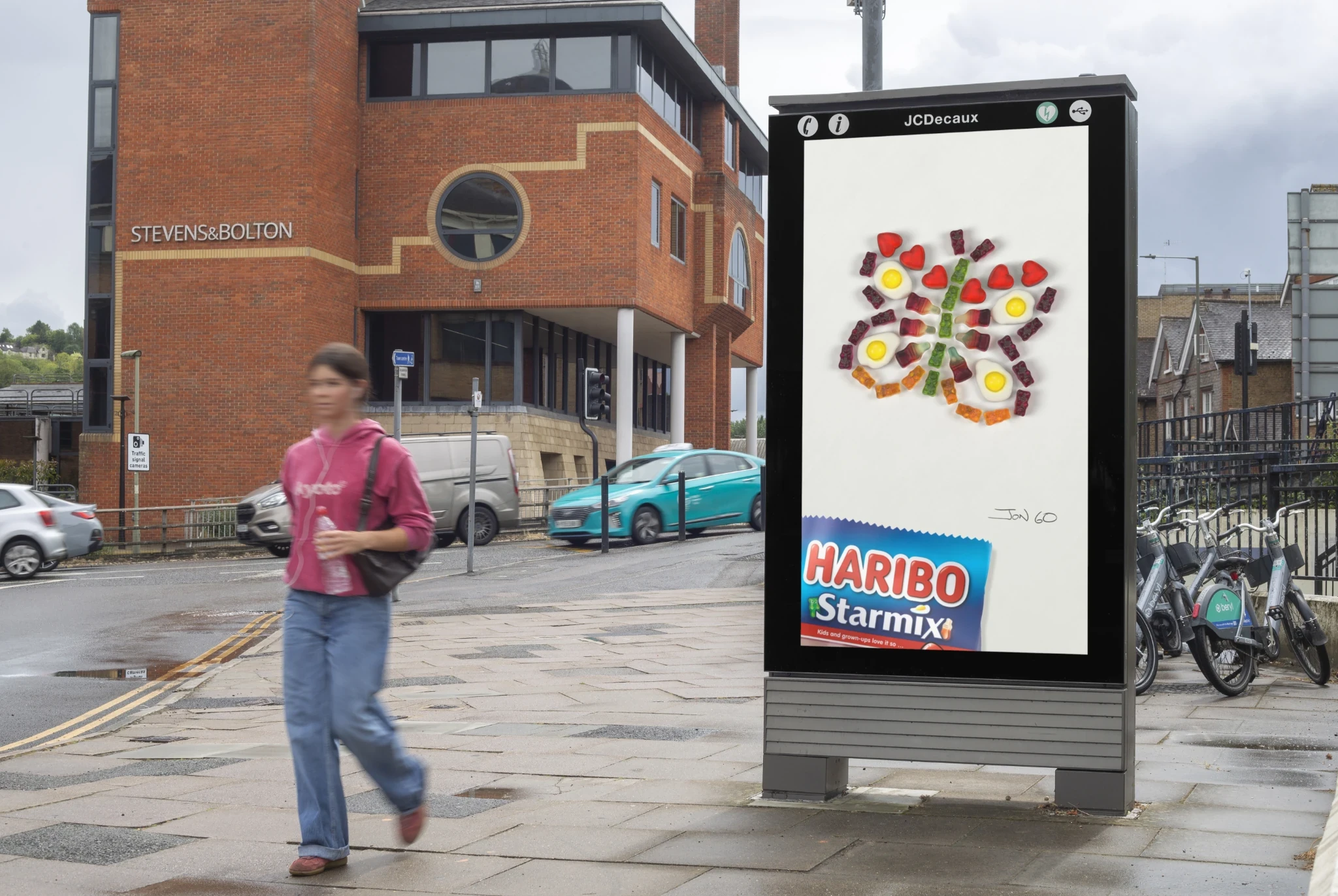 HARIBO Starmix street furniture OOH advertisement showing colorful gummy pieces arranged into an imaginative butterfly-like figure.