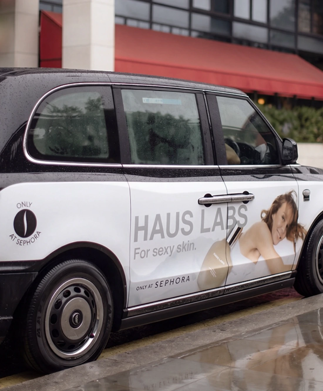 Haus Labs London black cab with For sexy skin messaging, model photography, product imagery and Only at Sephora branding.