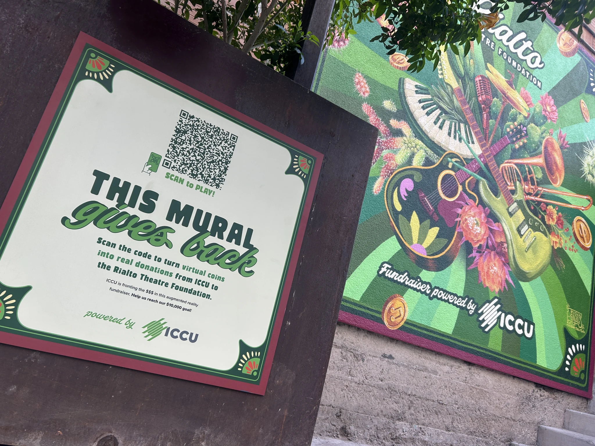 ICCU interactive OOH mural in Tucson with a QR code sign inviting visitors to play an augmented reality coin game supporting the Rialto Theatre Foundation.