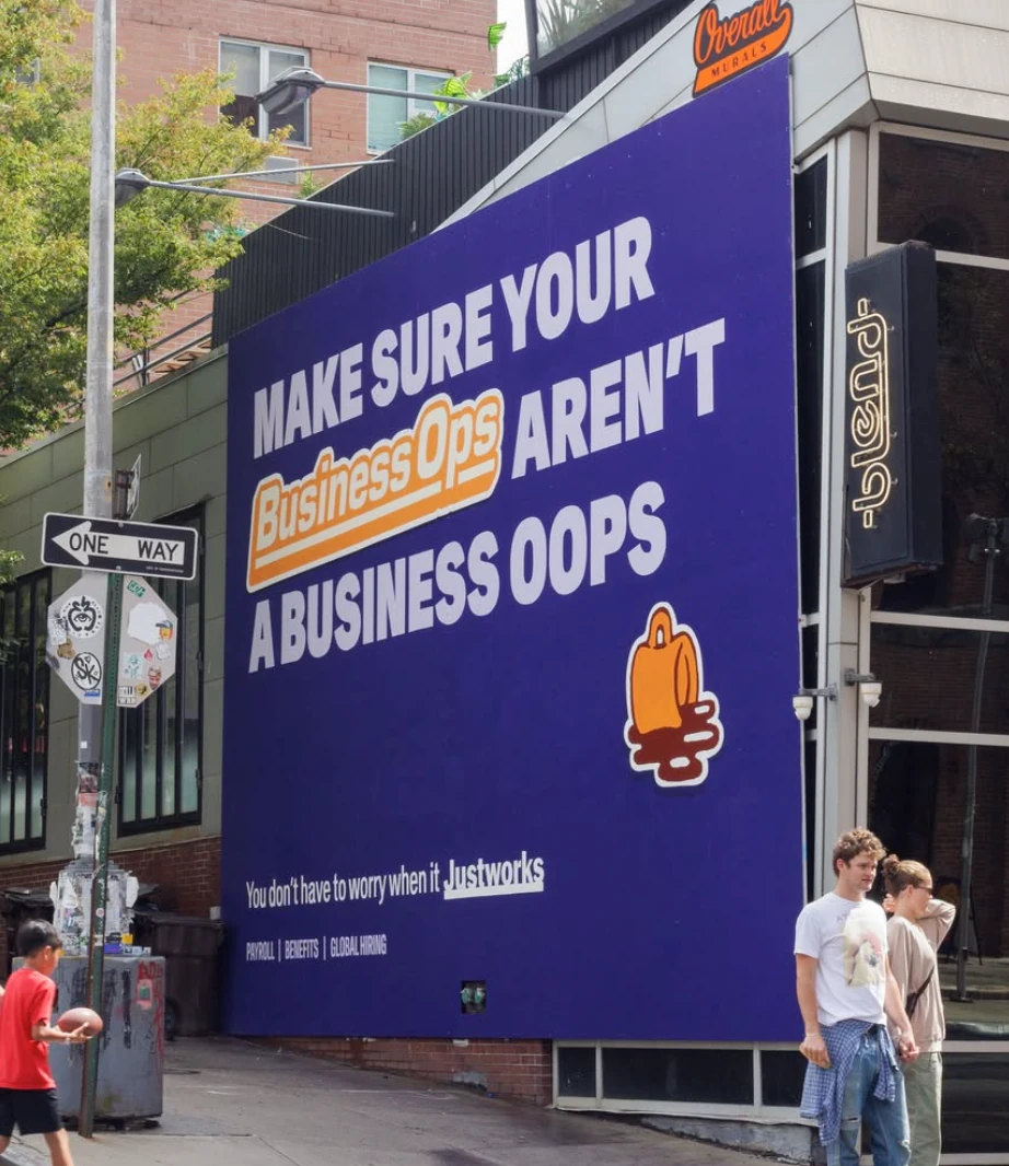 Justworks purple wall mural reading Make sure your Business Ops aren't a Business Oops.