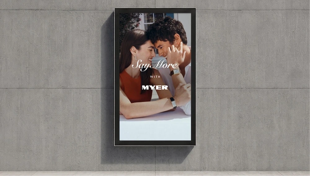 Myer Say More with Myer vertical OOH campaign showing a couple sharing an intimate moment.