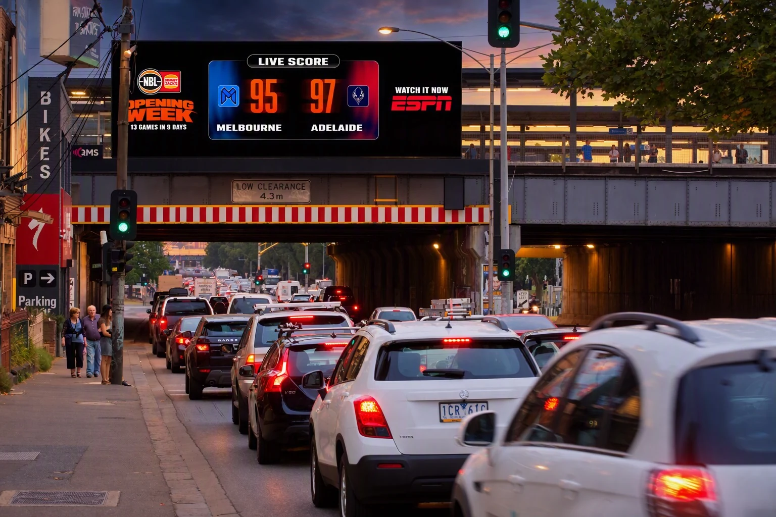 NBL Play It Loud Digital Out-of-Home billboard at Punt Road in Melbourne showing a live Melbourne versus Adelaide basketball score during Opening Week.
