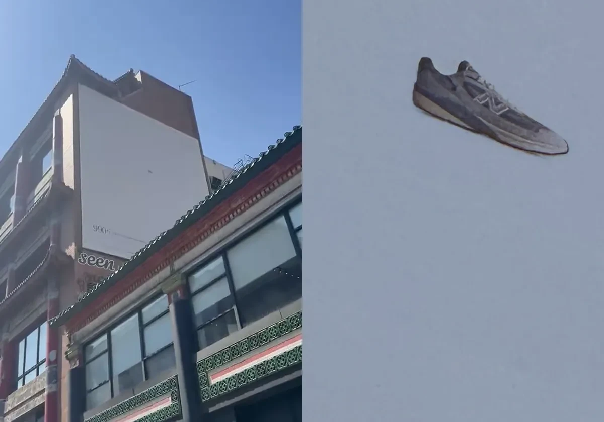 New Balance 990v7 minimalist billboard in New York showing a tiny grey sneaker against an almost completely empty pale background.