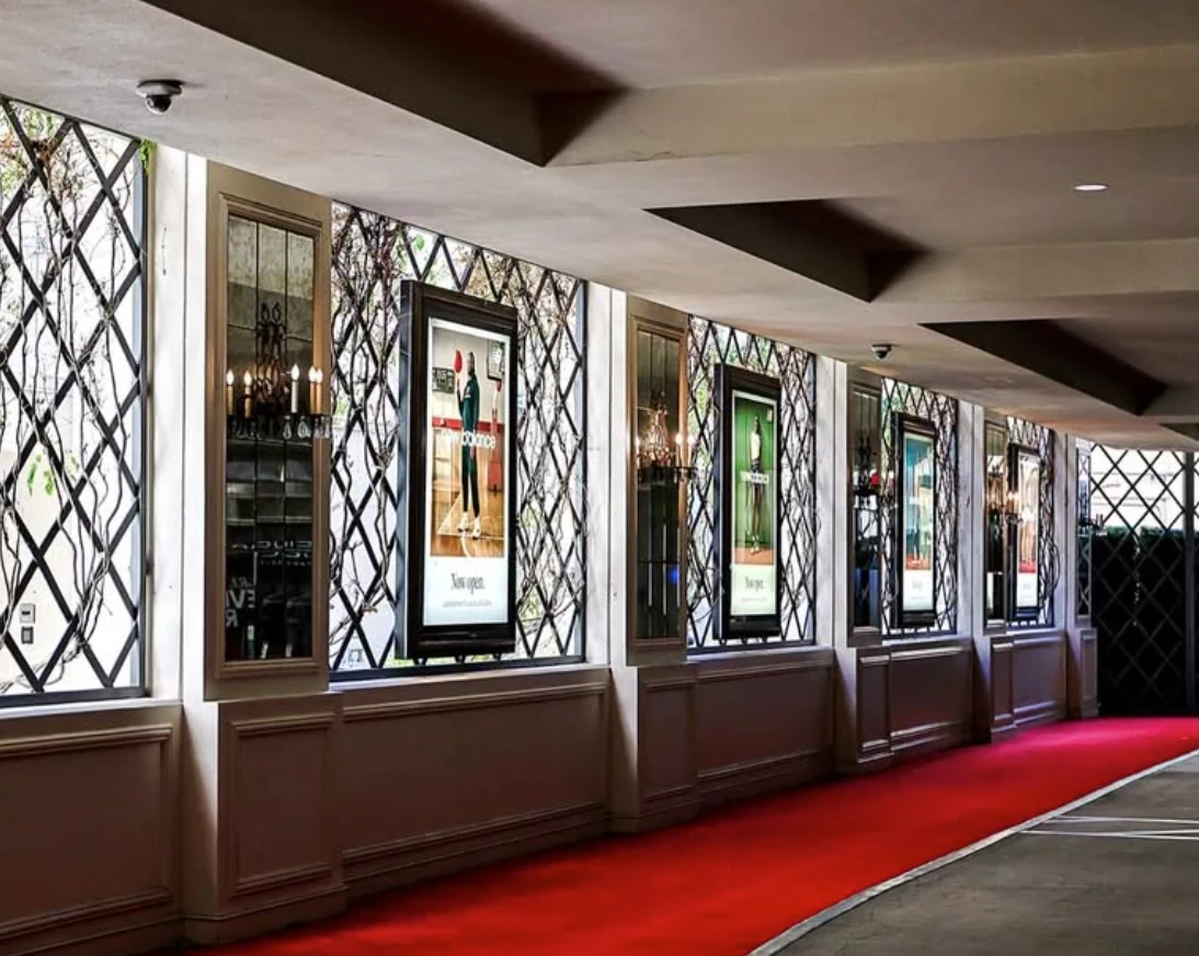 Series of illuminated New Balance ads installed along an interior corridor at The Grove.