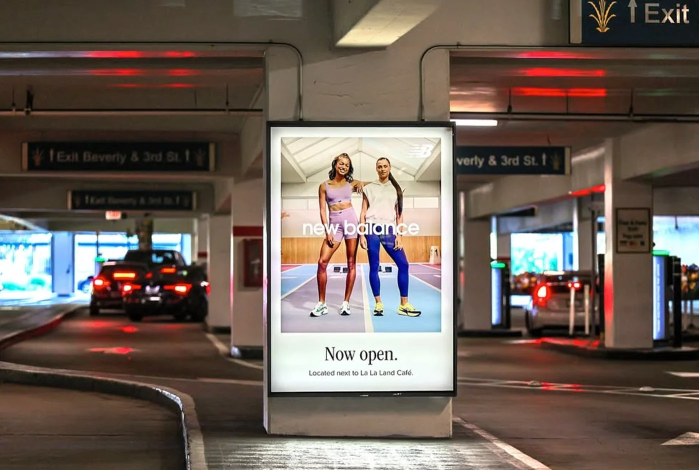 New Balance illuminated OOH display in The Grove valet and parking area promoting the newly opened store with two athletes.