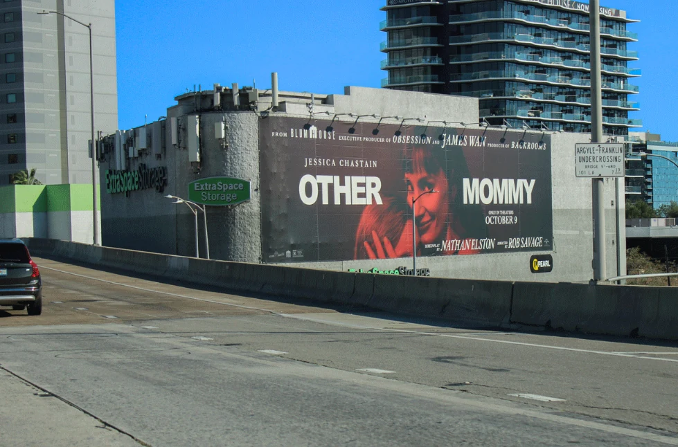 Other Mommy horror movie OOH billboard on a Los Angeles building beside a roadway, featuring Jessica Chastain and the October 9 theatrical date.