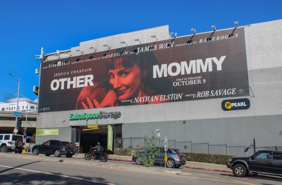 Front-facing view of the Other Mommy Universal Pictures outdoor billboard in Los Angeles, showing Jessica Chastain, the film title and October 9 release messaging.