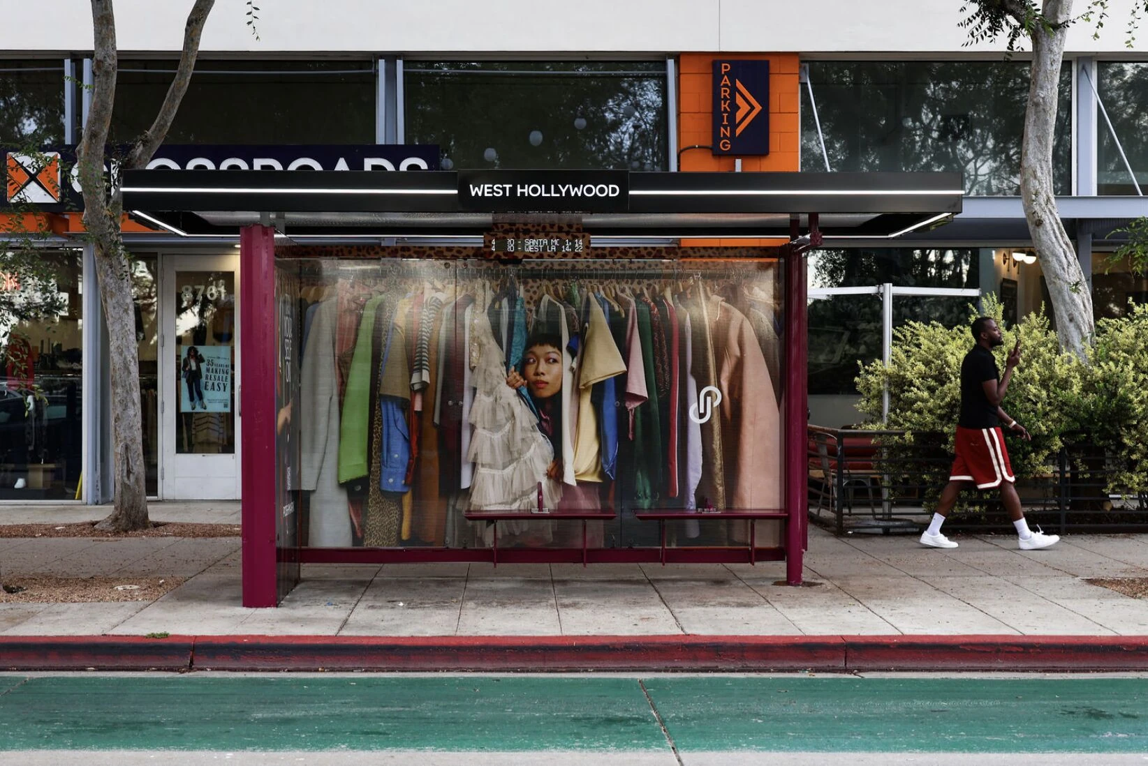 Poshmark bus shelter in West Hollywood transformed with a full wardrobe-style fashion image across the shelter panels.
