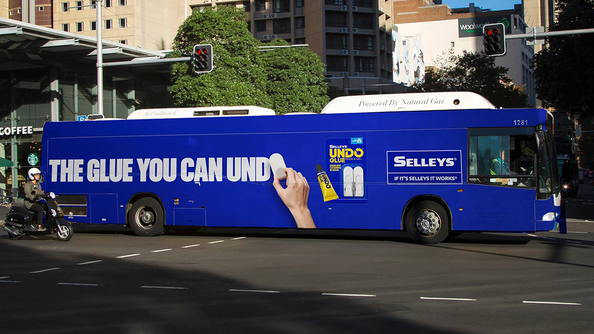 Blue city bus wrapped in Selleys Undo Glue advertising with the line The glue you can undo.