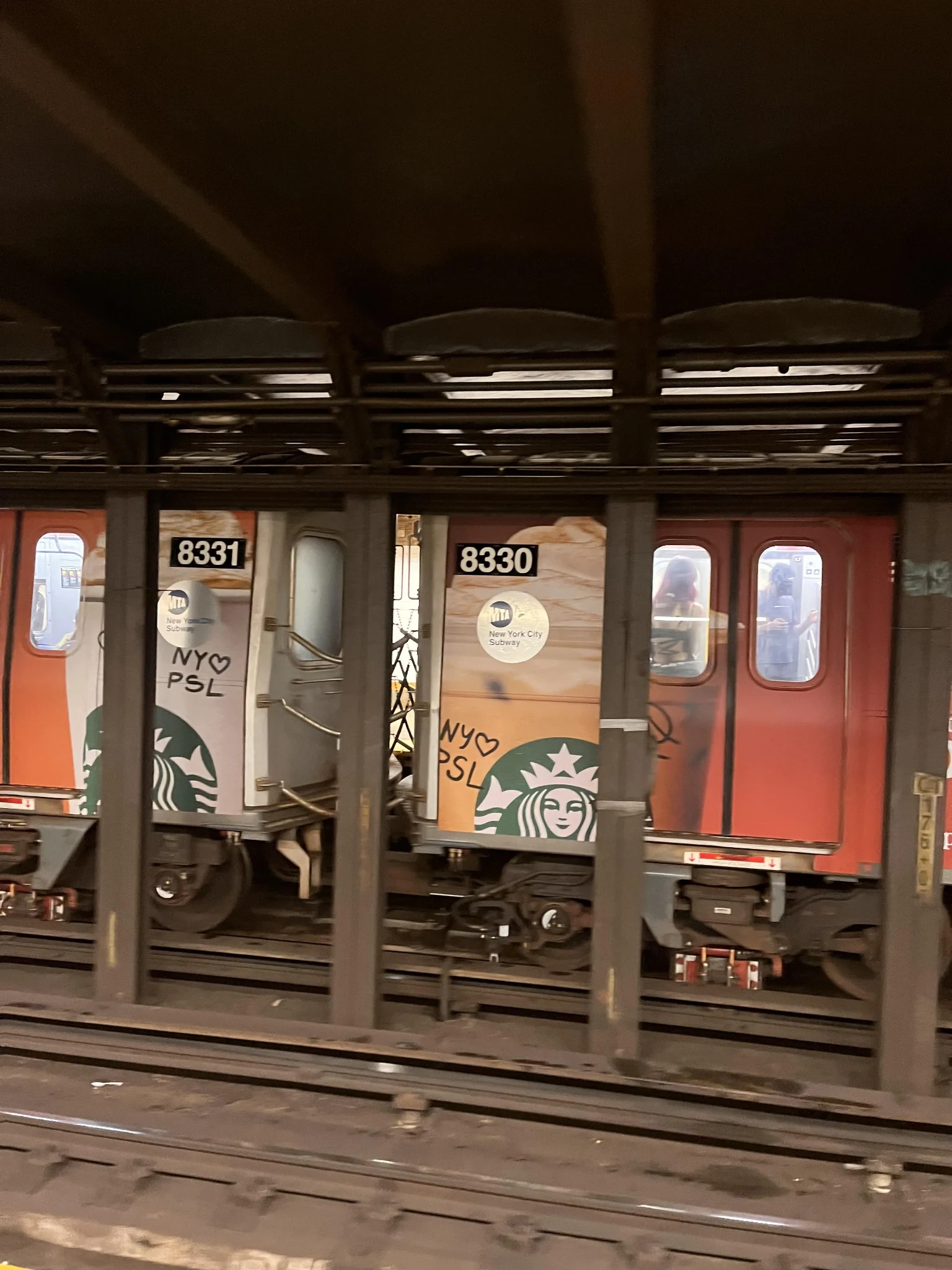 Starbucks Pumpkin Spice Latte wrapped MTA L train showing orange and cream seasonal branding across multiple subway cars.