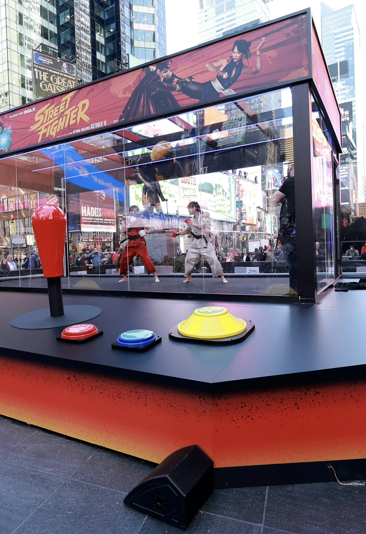 Street Fighter experiential OOH activation in Times Square featuring a giant arcade-style installation with live performers dressed as Ryu and Ken and oversized game controls.