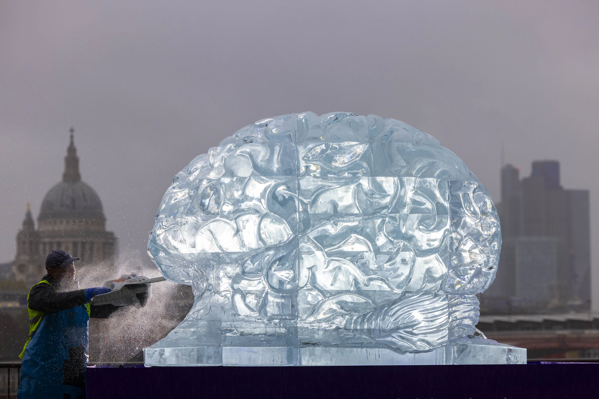 Worker carving the Stroke Association's large ice brain sculpture on London Southbank for Survival Is Not Enough experiential OOH campaign.