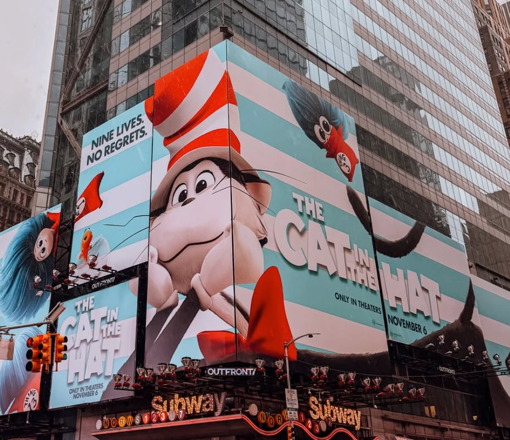 Large corner billboard takeover in Times Square for The Cat in the Hat Movie with oversized character artwork and November 6 release messaging.