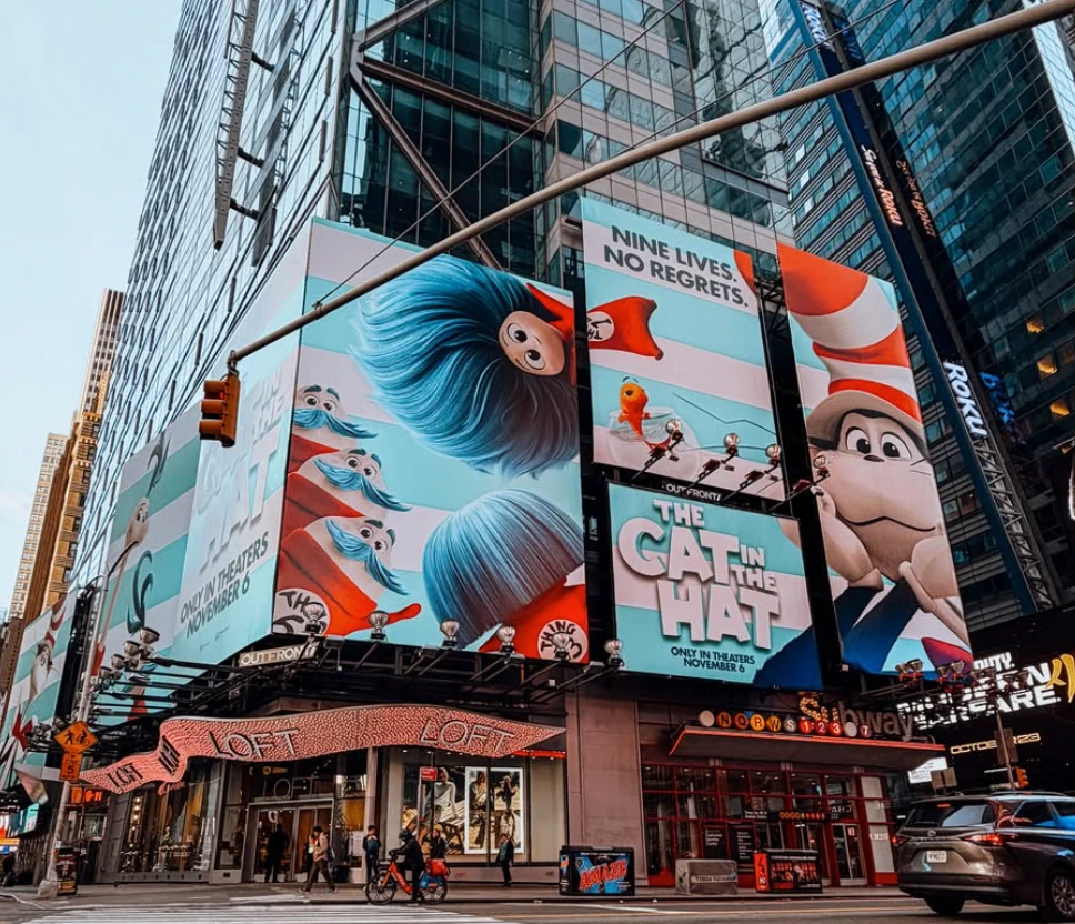 Wide view of The Cat in the Hat Movie OOH takeover across multiple Times Square billboards.