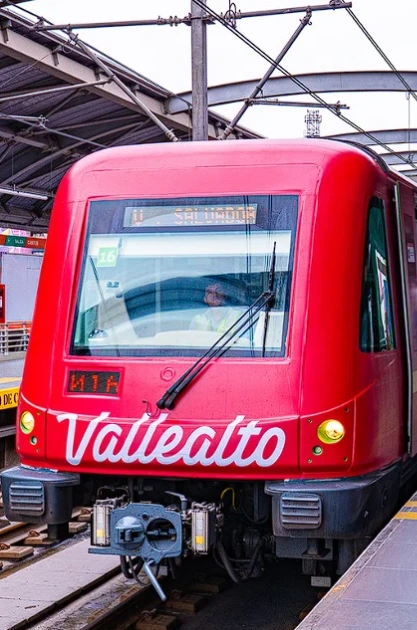 Front of a bright red Vallealto branded train on Lima Metro Line 1 in Peru, illustrating transit advertising and creative OOH media.