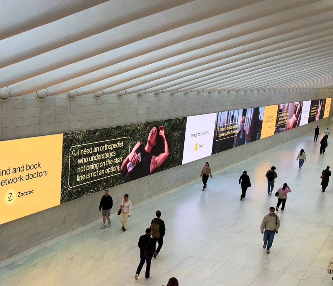 Large Zocdoc digital transit takeover in New York showing multiple doctor search messages across a long media wall.